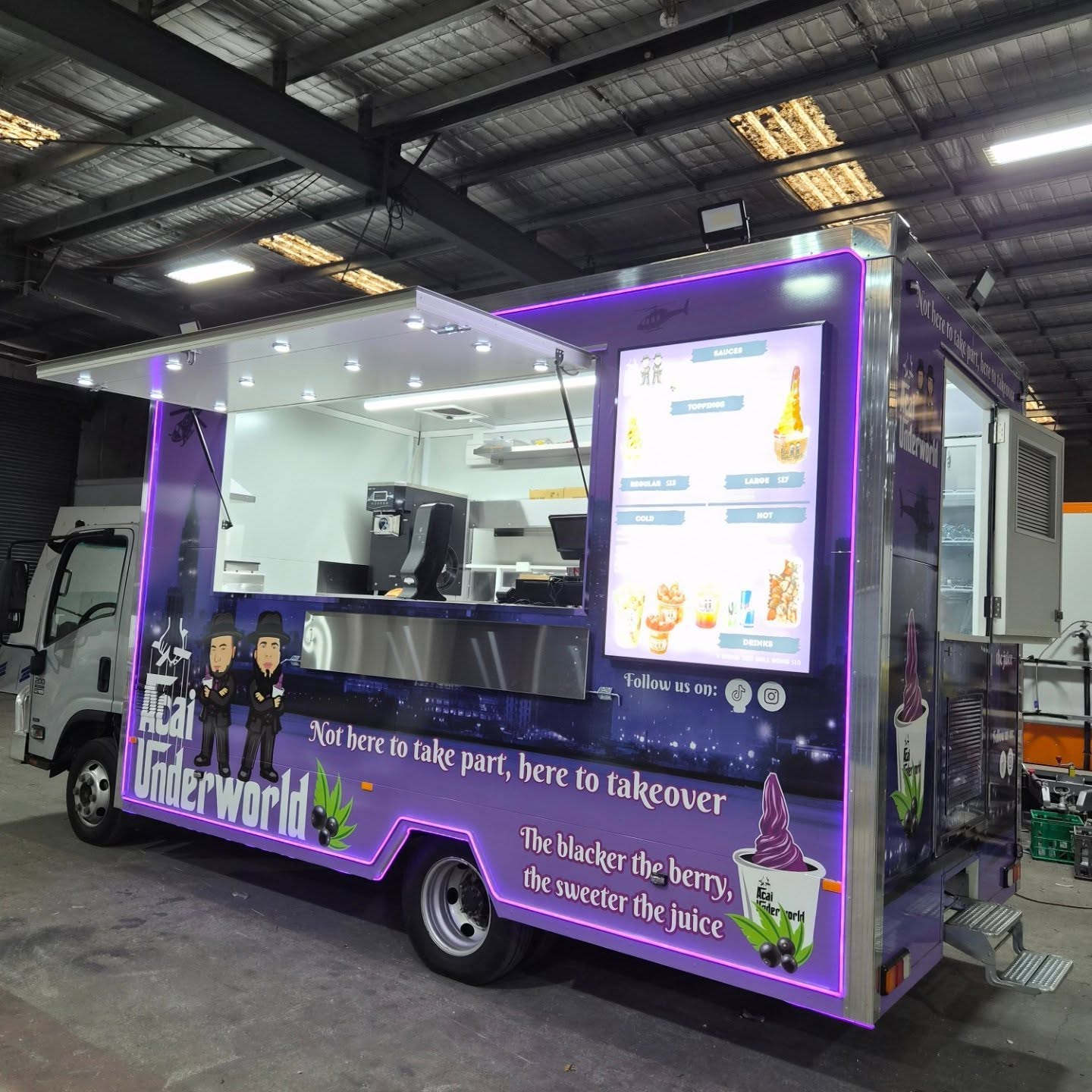 Acai Underworld food truck built by Prestige Food Vans with deep purple wrap, neon trim and built in digital menu screen