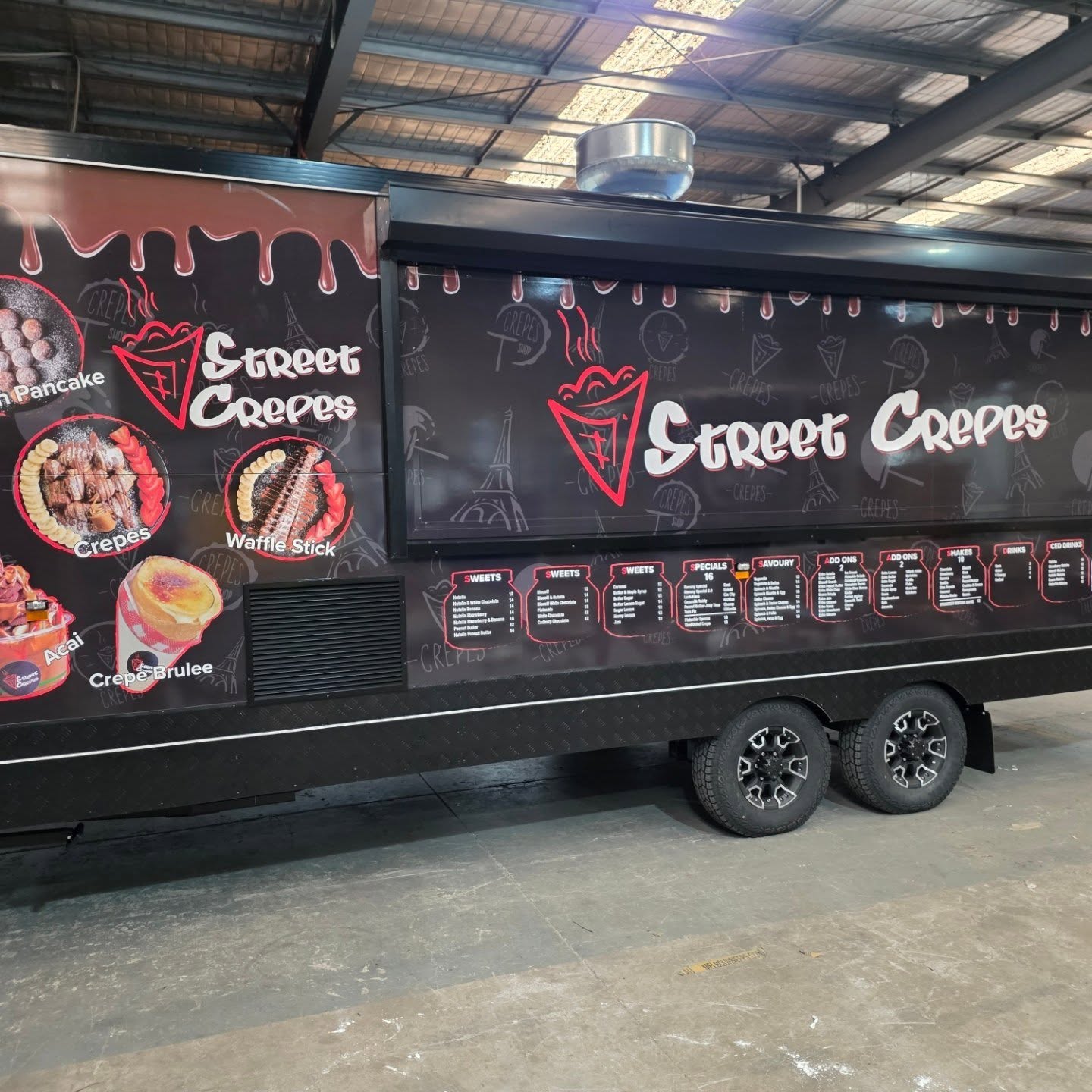 Street Crepes trailer built by Custom Food Vans with black drip wrap and full menu board