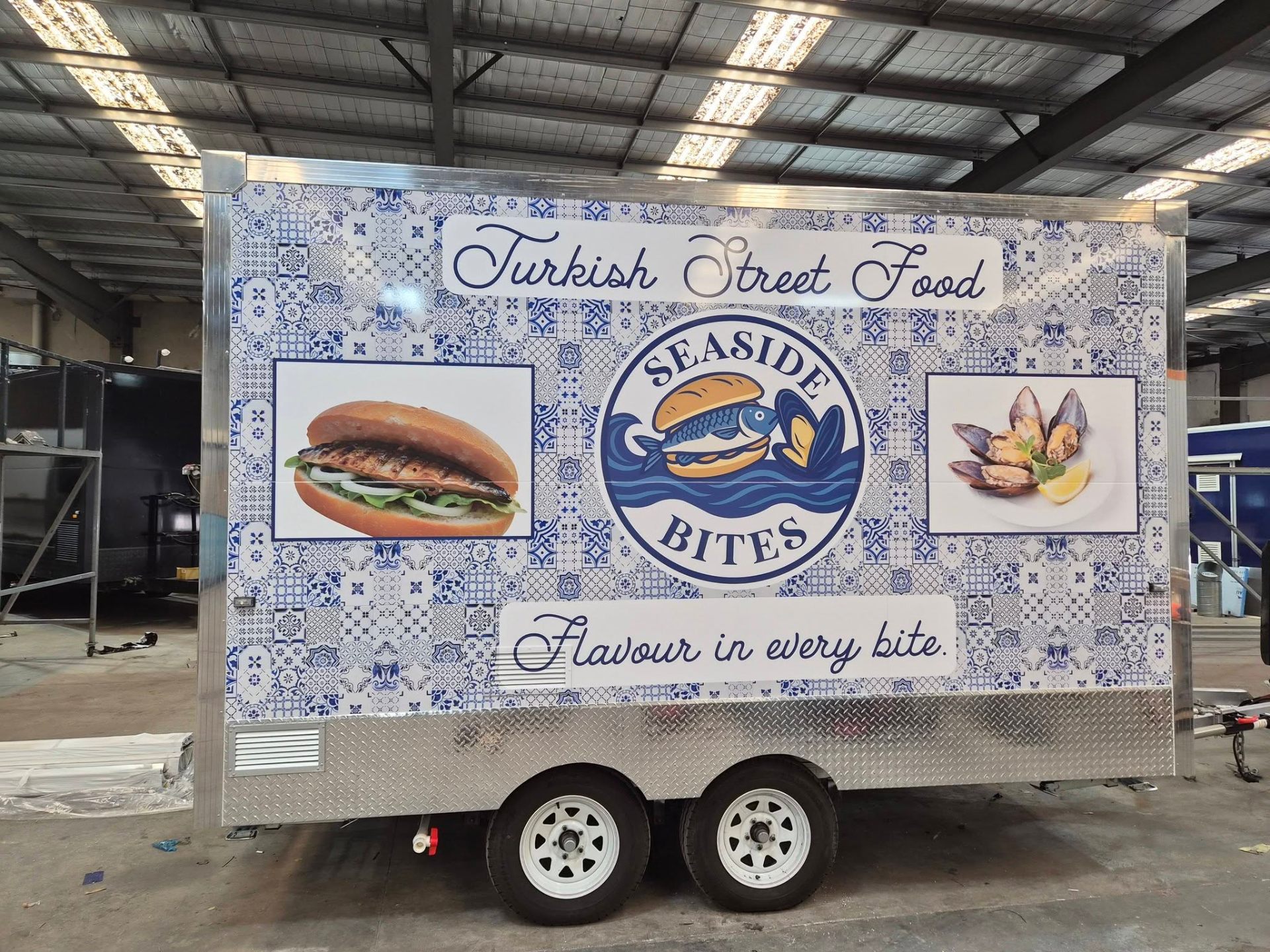 Seaside Bites Turkish street food trailer built by Prestige Food Vans with blue Mediterranean tile wrap and illuminated signage