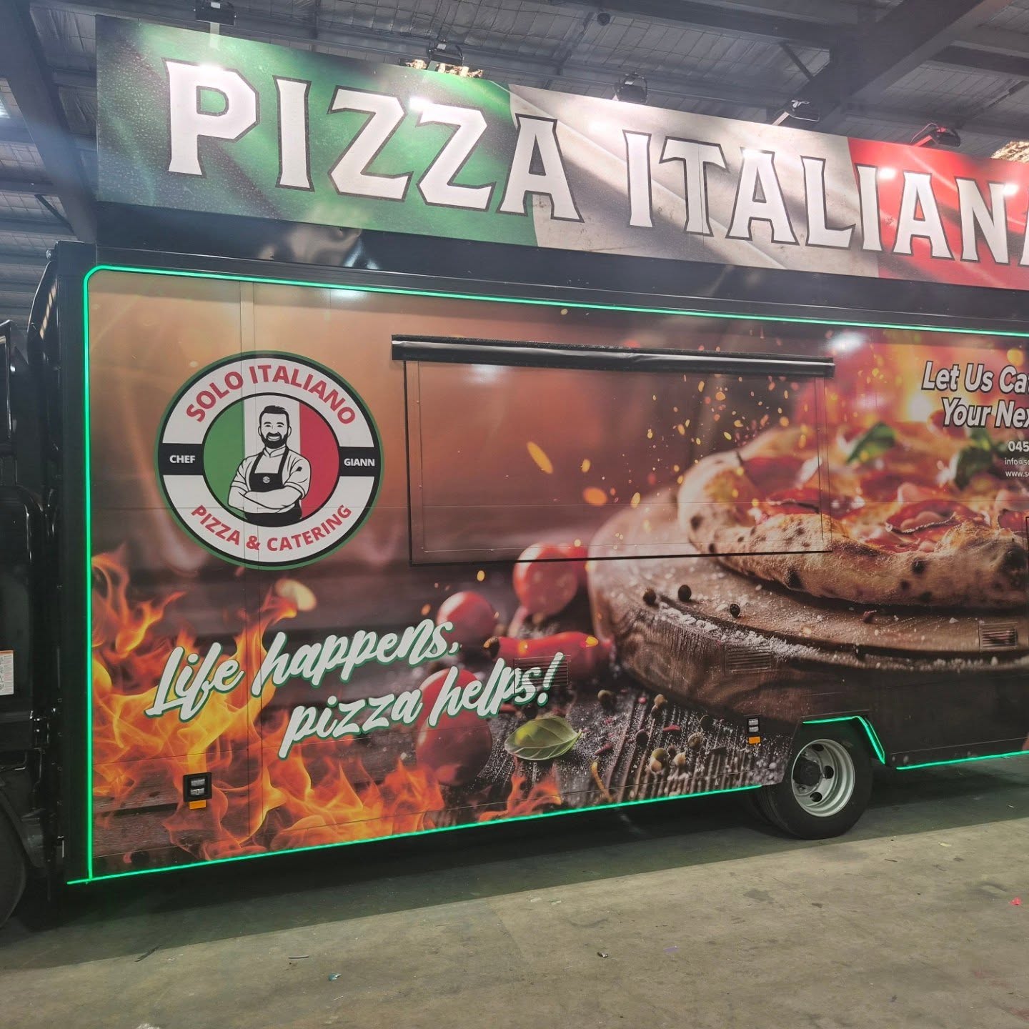 Solo Italiano Pizza Italiana food truck built by Custom Food Vans with green neon trim and Italian flag banner