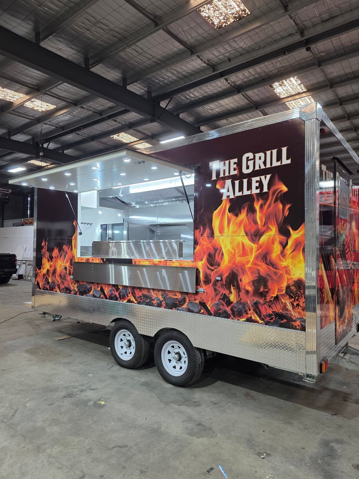The Grill Alley charcoal grill trailer built by Custom Food Vans with full flame wrap and stainless steel serving counter