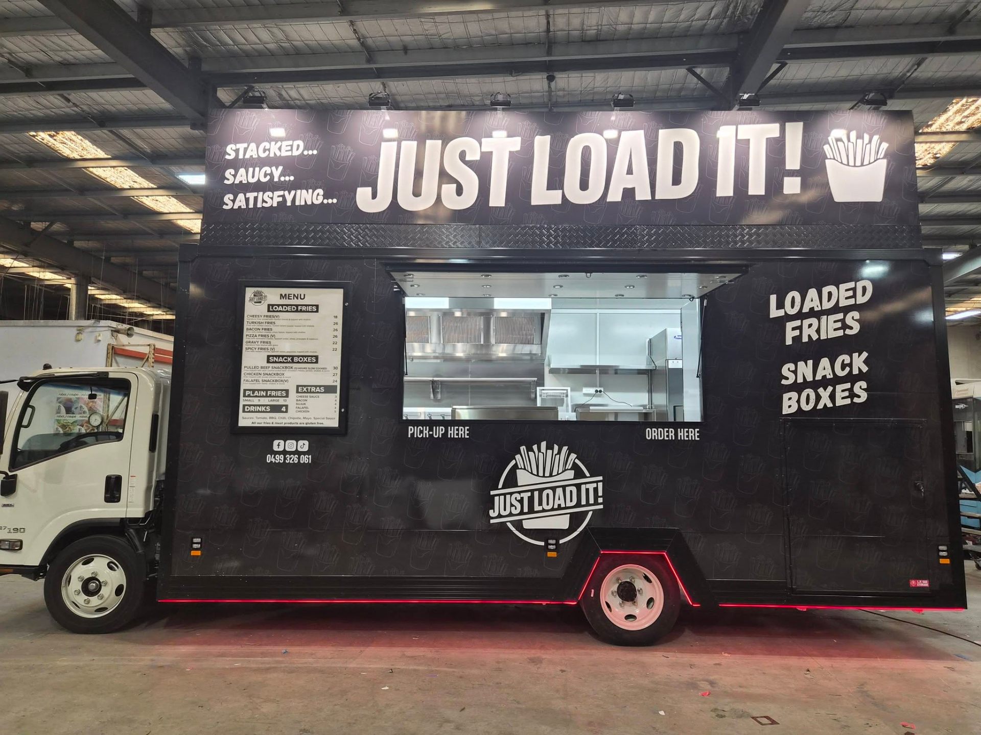 Just Load It loaded fries food truck built by Prestige Food Vans with matte black wrap, illuminated menu board and stainless serving counter
