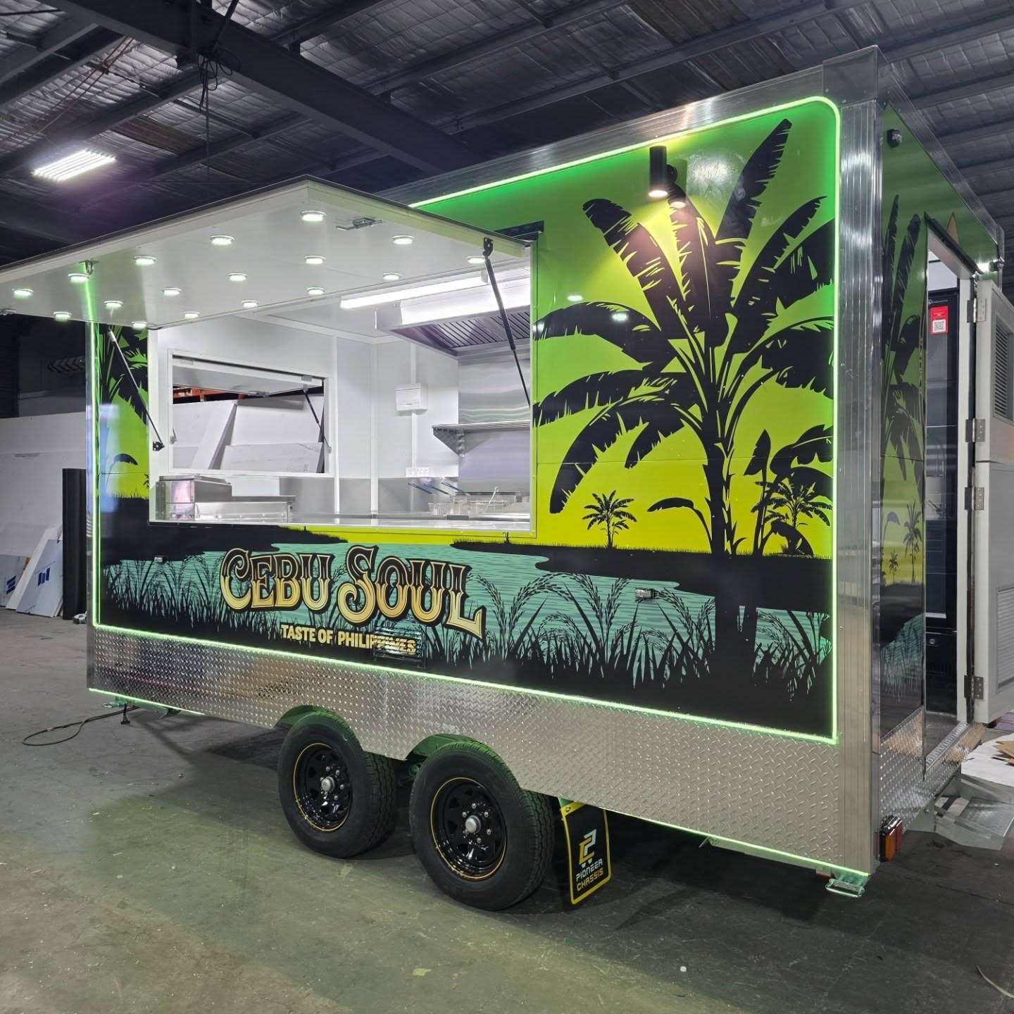 Cebu Soul Filipino food trailer built by Prestige Food Vans with tropical palm wrap, green neon outline and full kitchen fit out
